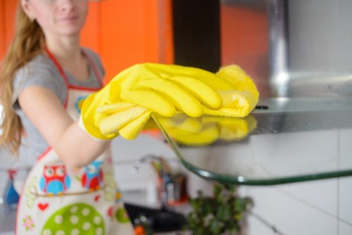 Oven racks and trays being cleaned as part of a kitchen deep clean